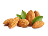 Almonds with green leaves on a white background