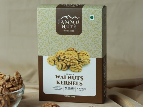 Box of Jammu Nuts walnuts kernels with a bowl of walnuts on a beige background