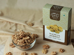 Jammu Nuts packaging with walnuts on a wooden surface